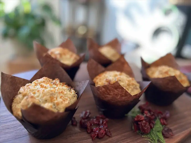 Golden lemon cranberry muffins with vibrant cranberries, fresh from the oven at Mimi Delights bakery in Ottawa.