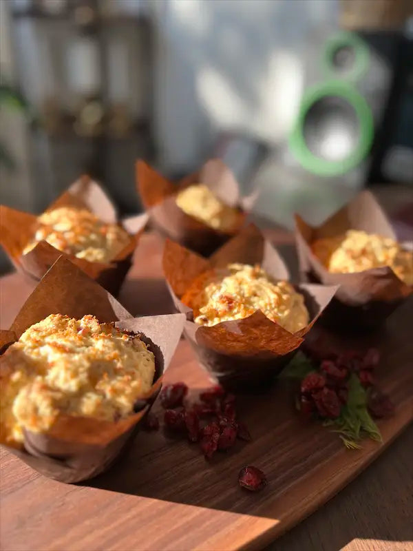 A tray of lemon cranberry muffins arranged for display at Mimi Delights, showcasing their moist texture and bright cranberry pieces.