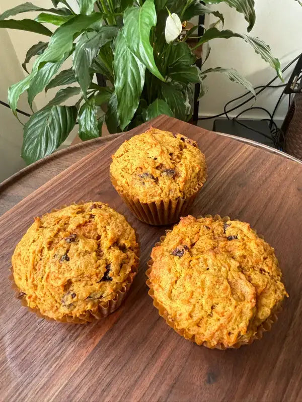 three_morning_glory_muffins_on_the_small_wooden_table