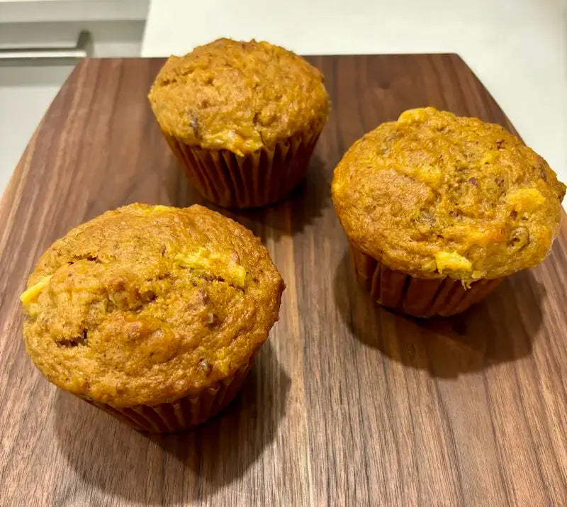three_pineapple_raisin_trio_of_muffins_on_the_wooden_tray